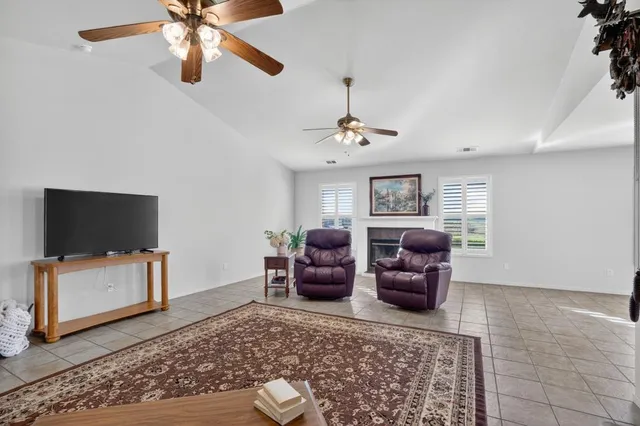 a view of an empty room with a fireplace and a window