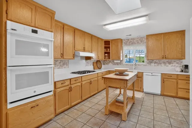 a kitchen with stainless steel appliances granite countertop a sink and cabinets