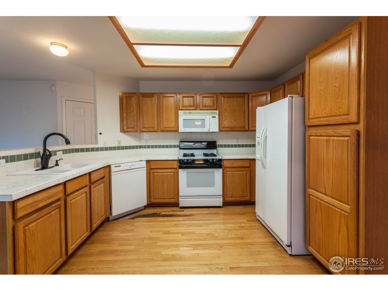 607 Rider Ridge Road Longmont, CO 80504 - Photo 3 of 30 a kitchen with stainless steel appliances granite countertop a refrigerator and a sink
