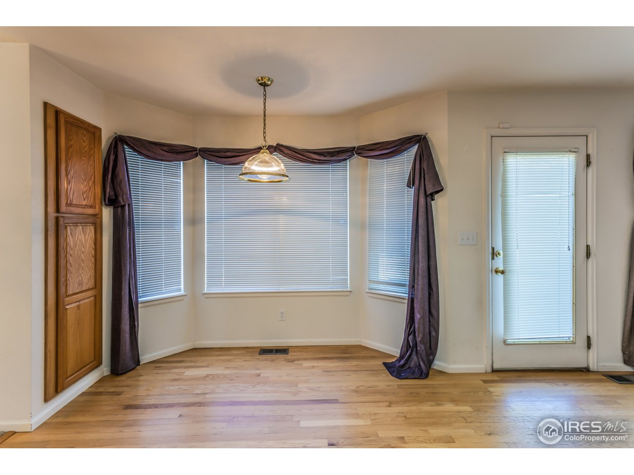 607 Rider Ridge Road Longmont, CO 80504 - Photo 4 of 30 a view of empty room with wooden floor and fan