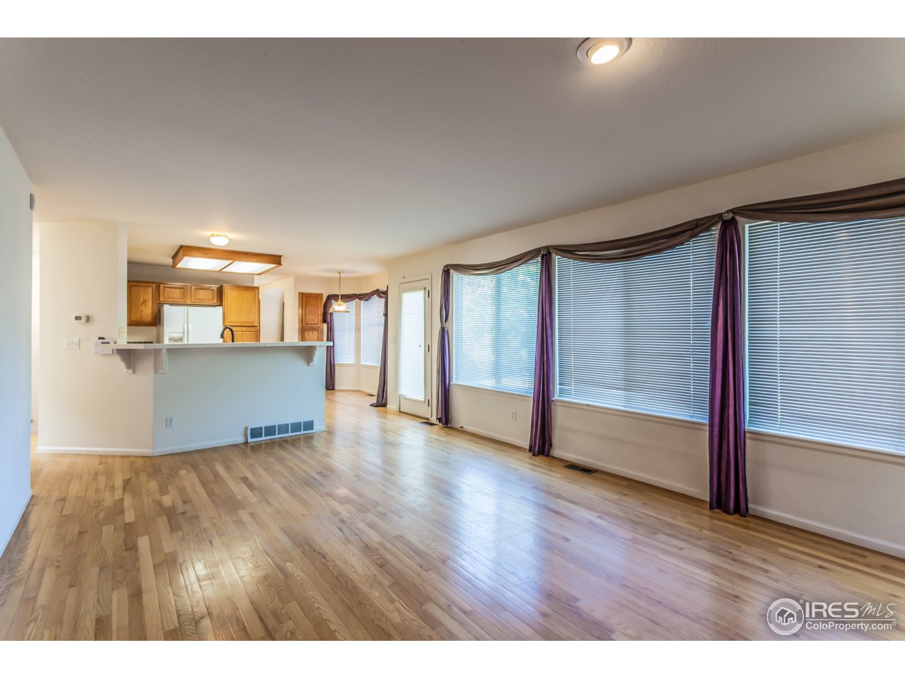 607 Rider Ridge Road Longmont, CO 80504 - Photo 7 of 30 a view of a big room with wooden floor and windows