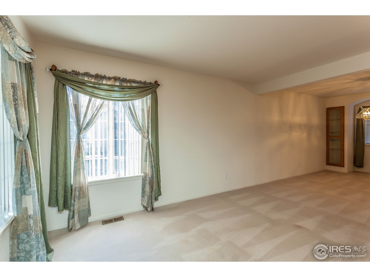 607 Rider Ridge Road Longmont, CO 80504 - Photo 8 of 30 a view of an empty room with a fireplace and a window