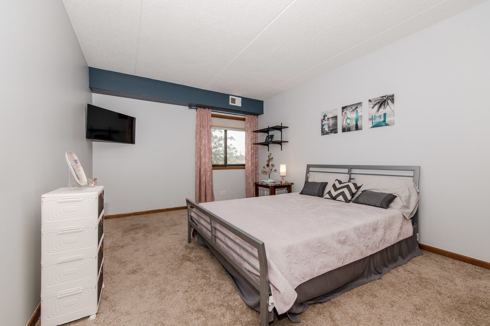 1504 Woodbridge Road, Unit 2E Joliet, IL 60436 - Photo 14 of 34 a bedroom with a bed and a flat screen tv