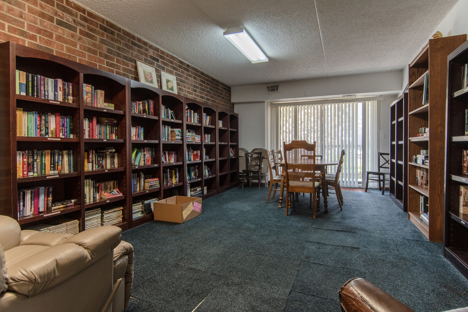1504 Woodbridge Road, Unit 2E Joliet, IL 60436 - Photo 23 of 34 a living room with furniture and a book shelf