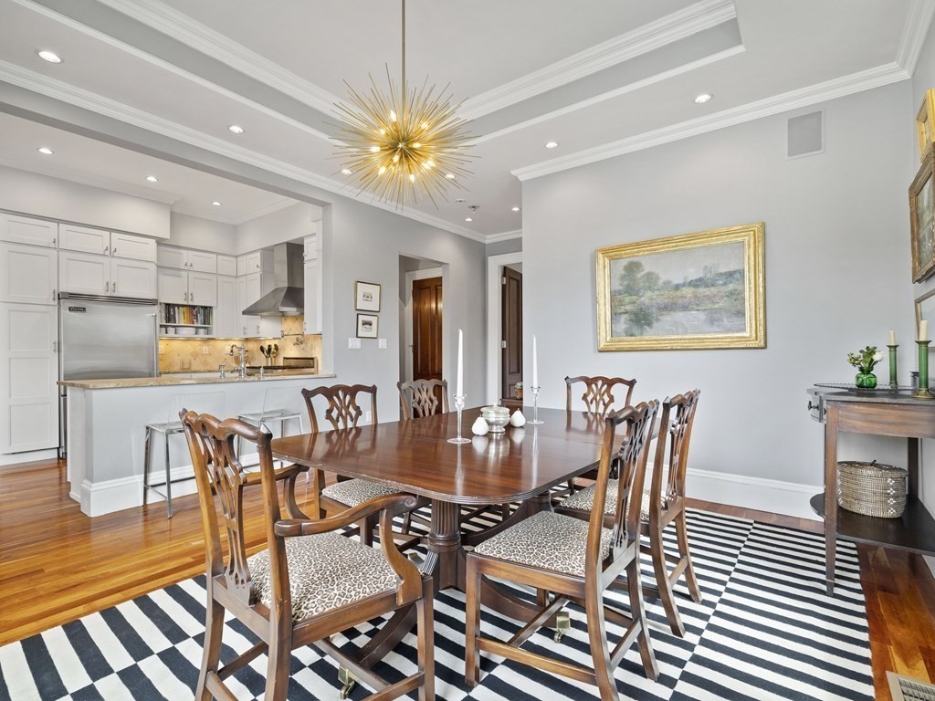 a view of a dining room with furniture a chandelier and wooden floor