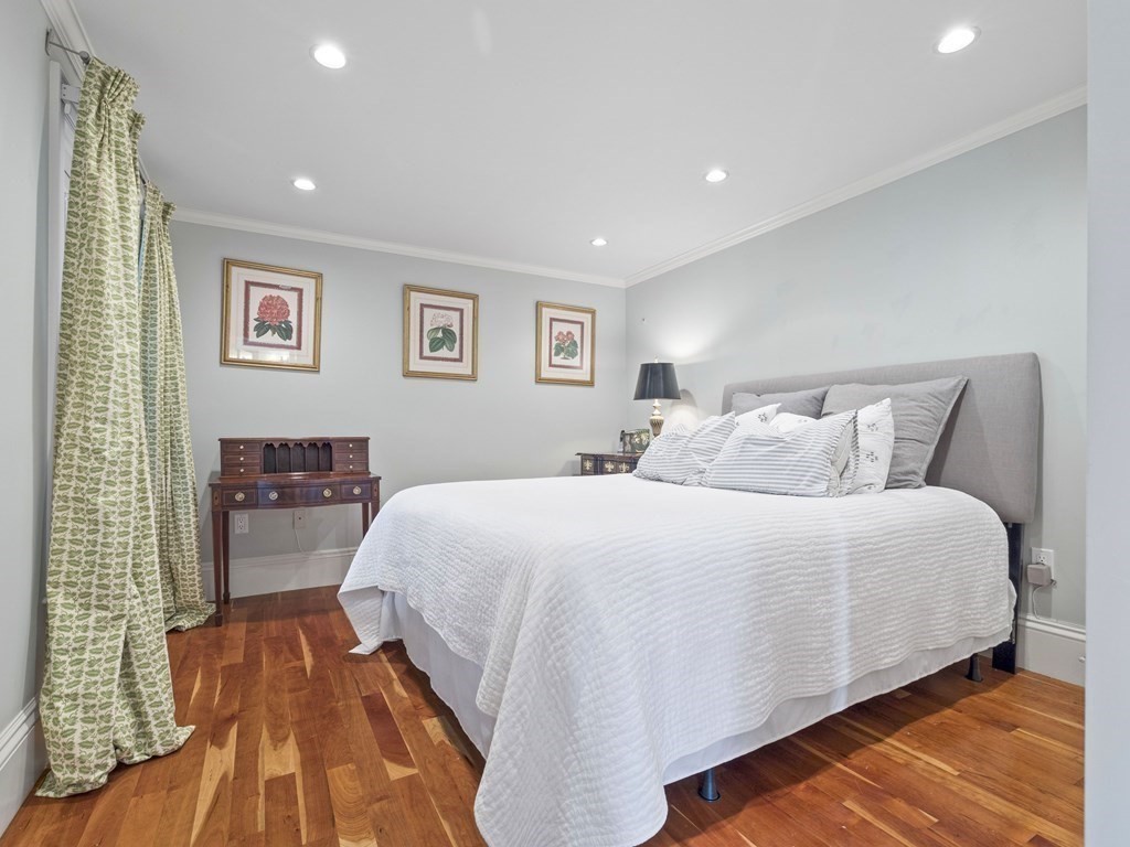 99 Sedgwick Street, Unit 1 Boston, MA 02130 - Photo 21 of 41 a spacious bedroom with a bed and a lamp
