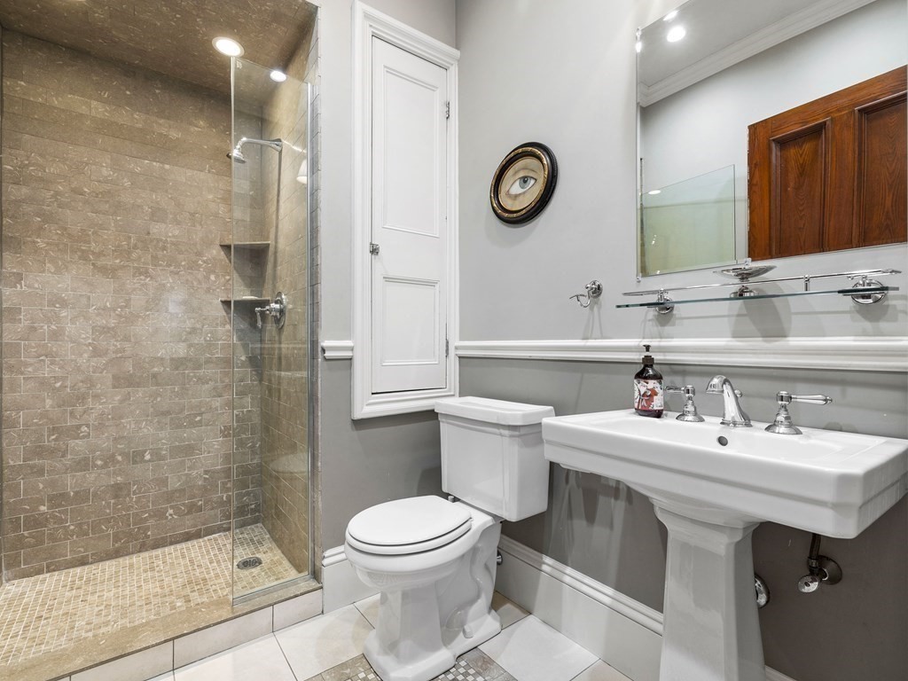 99 Sedgwick Street, Unit 1 Boston, MA 02130 - Photo 24 of 41 a bathroom with a sink mirror vanity and toilet