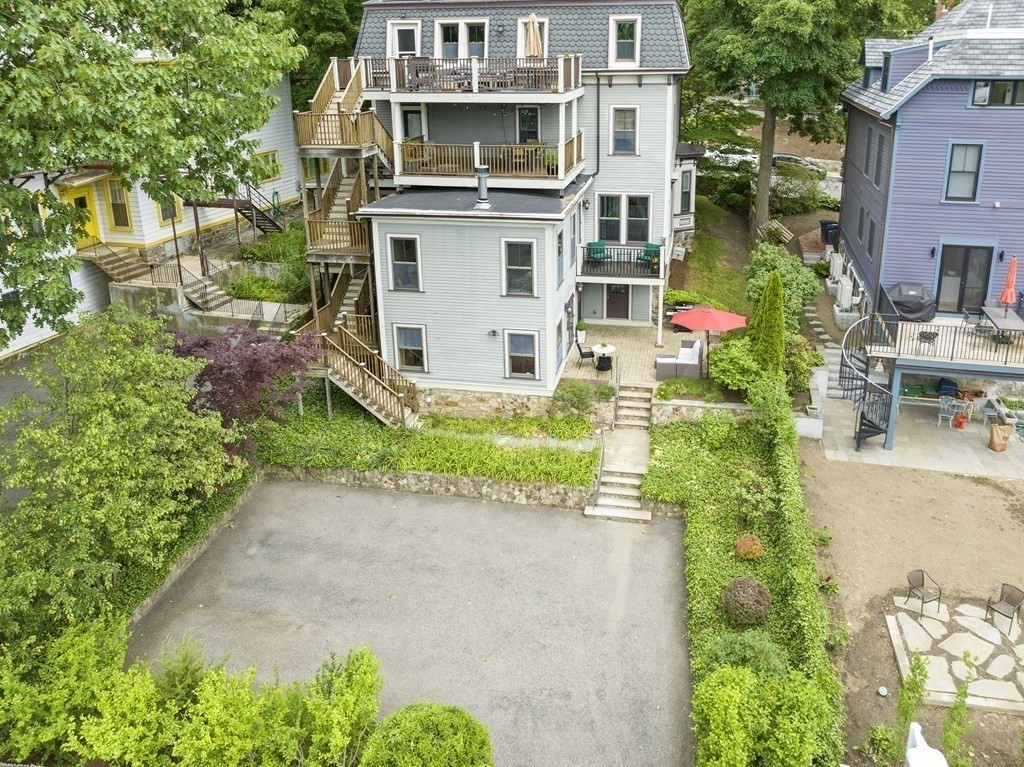 99 Sedgwick Street, Unit 1 Boston, MA 02130 - Photo 30 of 41 a white house with a yard and plants