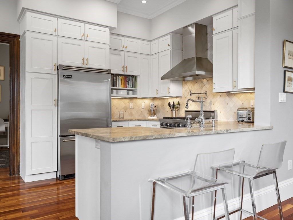 99 Sedgwick Street, Unit 1 Boston, MA 02130 - Photo 6 of 41 a kitchen with stainless steel appliances granite countertop a sink and a refrigerator