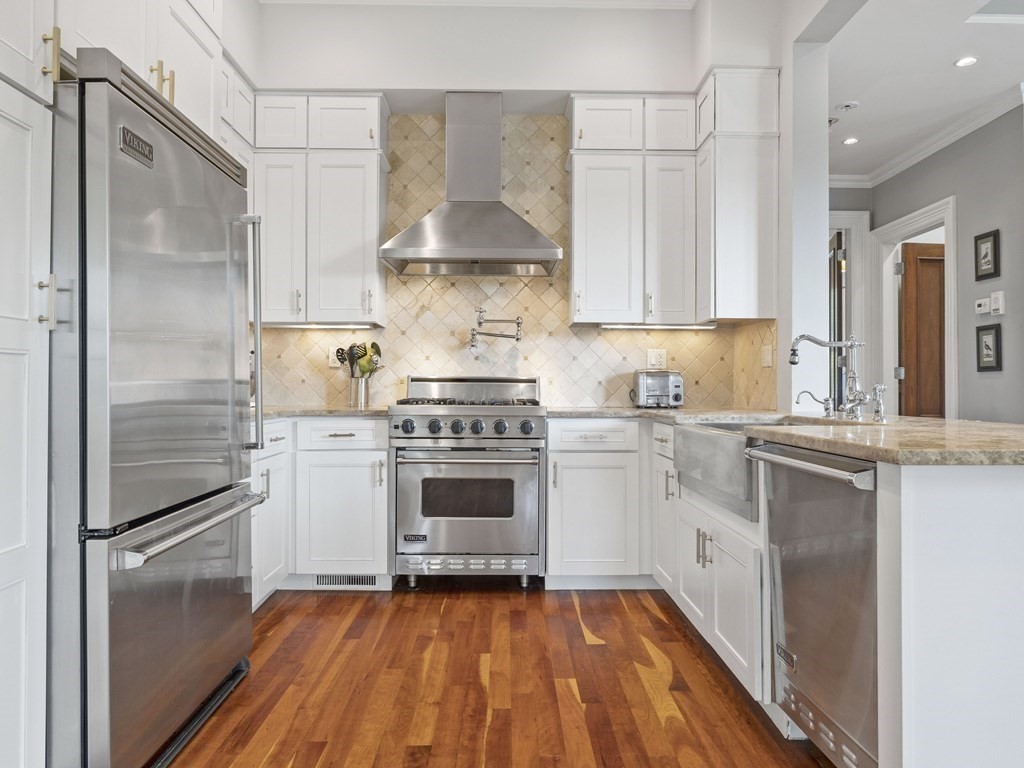 99 Sedgwick Street, Unit 1 Boston, MA 02130 - Photo 7 of 41 a kitchen with a stove a refrigerator and a sink