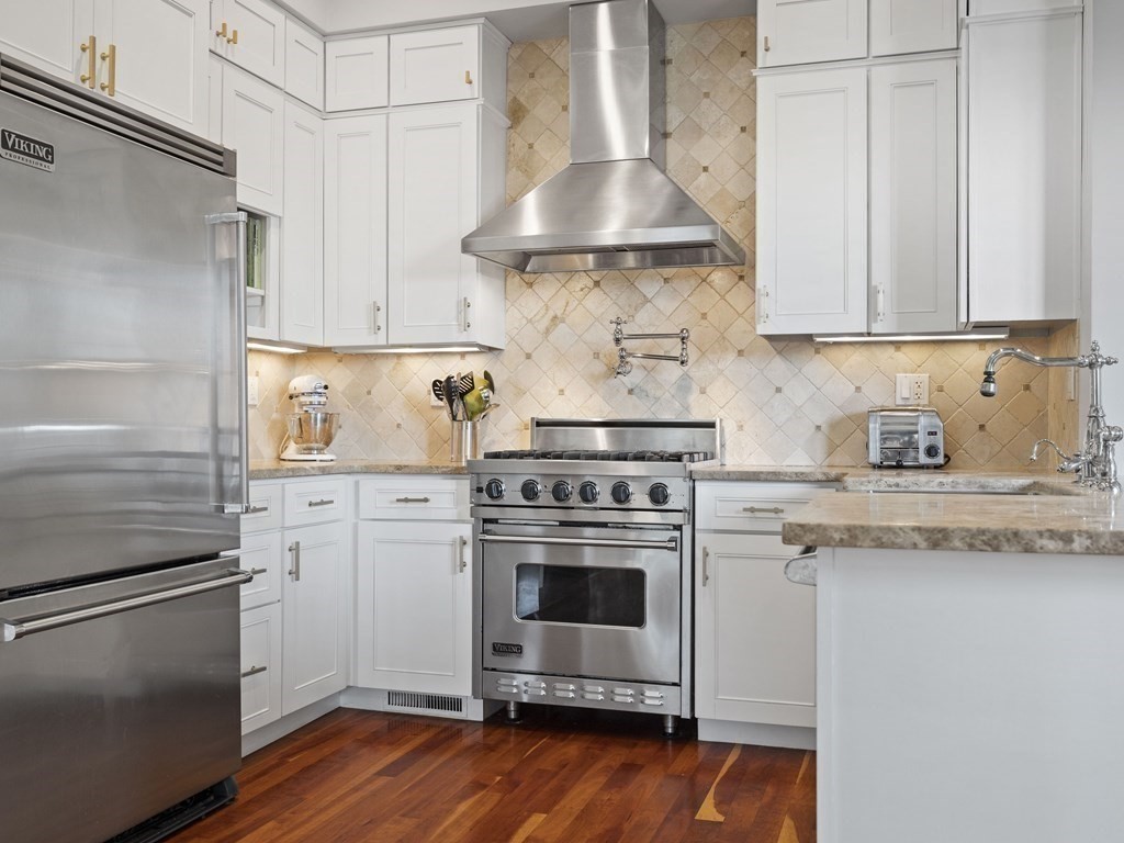 99 Sedgwick Street, Unit 1 Boston, MA 02130 - Photo 8 of 41 a kitchen with a stove and a refrigerator