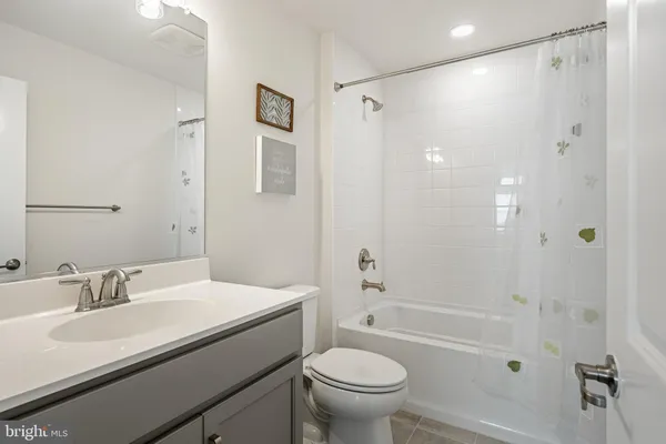 a bathroom with a sink toilet double vanity and shower