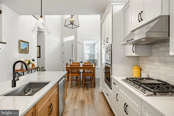 a kitchen with granite countertop a sink stove and cabinets