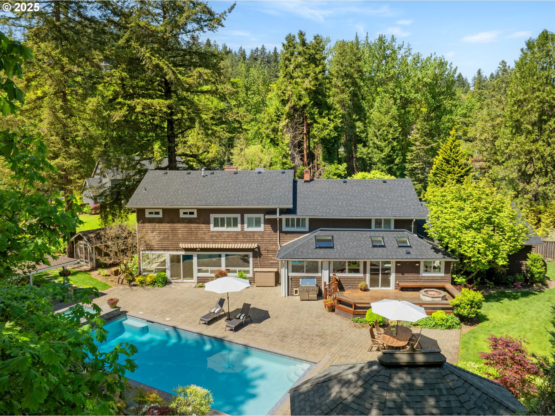 aerial view of a house with swimming pool garden and patio