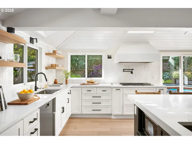 a open kitchen with stainless steel appliances kitchen island granite countertop a sink and cabinets