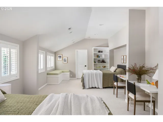 a spacious bedroom with a bed and a chair