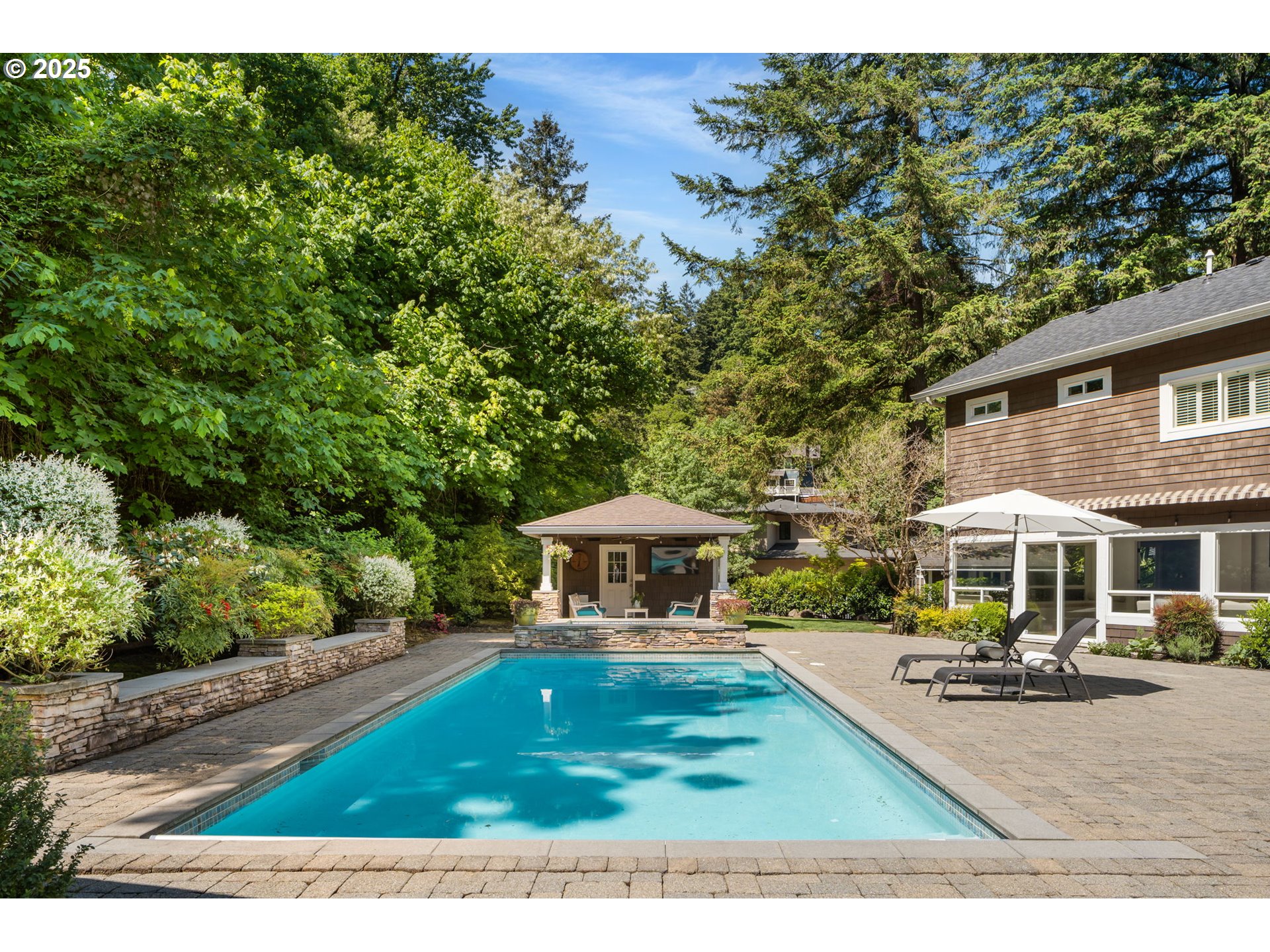 13740 Fielding Road Lake Oswego, OR 97034 - Photo 37 of 41 a view of a yard with plants and a table under an umbrella