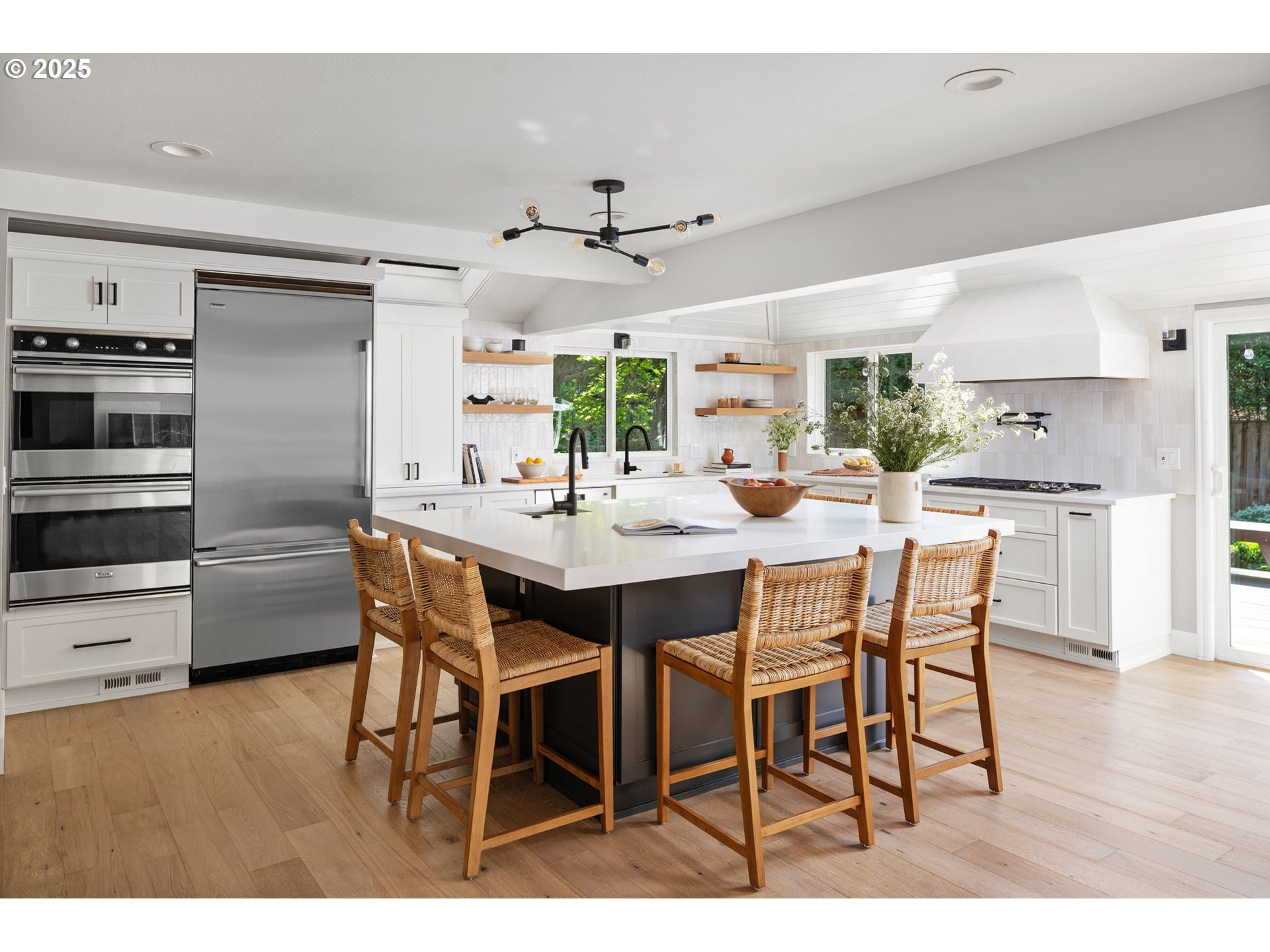 13740 Fielding Road Lake Oswego, OR 97034 - Photo 9 of 41 a kitchen with a dining table cabinets and stainless steel appliances