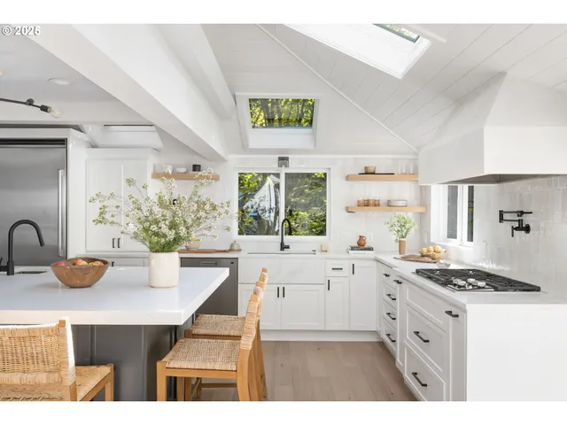 a kitchen with a stove a sink and a refrigerator