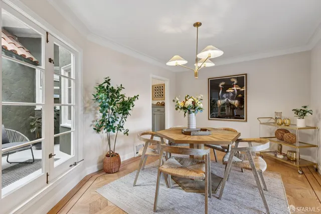 a dining room with furniture potted plants and wooden floor