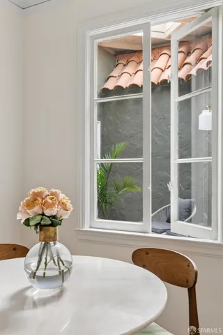 a bedroom with a bed and two windows