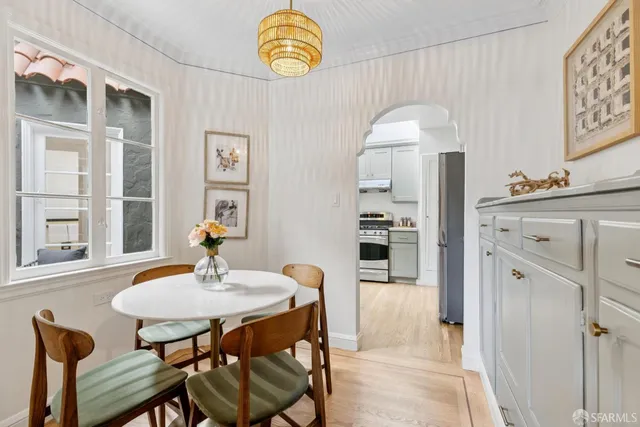 a kitchen with white cabinets and a stove