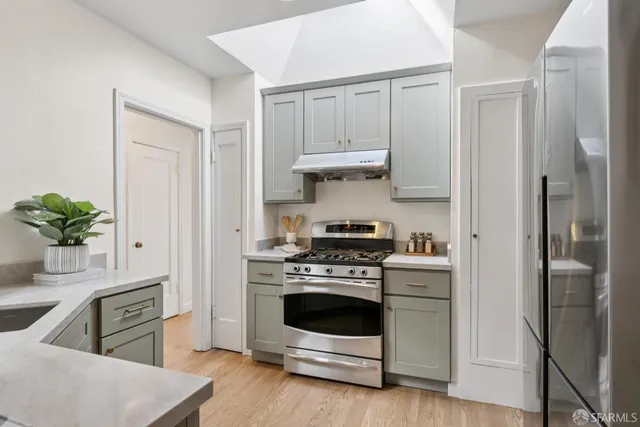 a kitchen with stainless steel appliances a refrigerator stove and sink