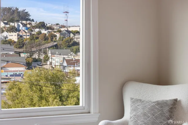 a bedroom with a bed and a large window