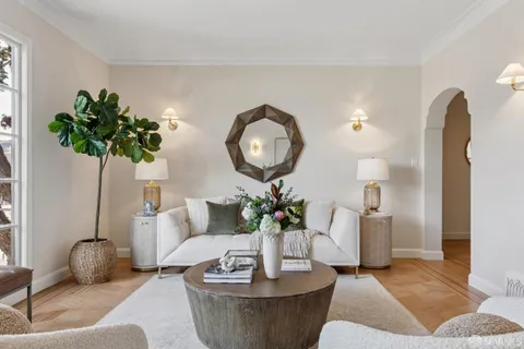 a living room with furniture and a potted plant