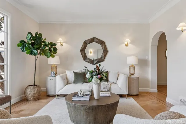 a living room with furniture and a potted plant
