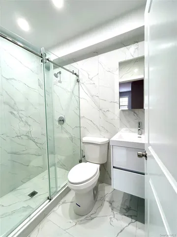 a bathroom with a toilet sink and a shower