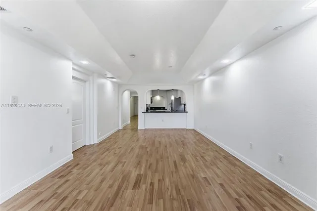 a view of empty room with wooden floor