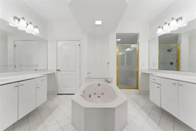 a spacious bathroom with a sink a mirror and a shower