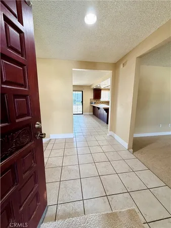a view of a livingroom with kitchen and furniture