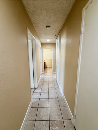 an empty room with a ceiling fan and window