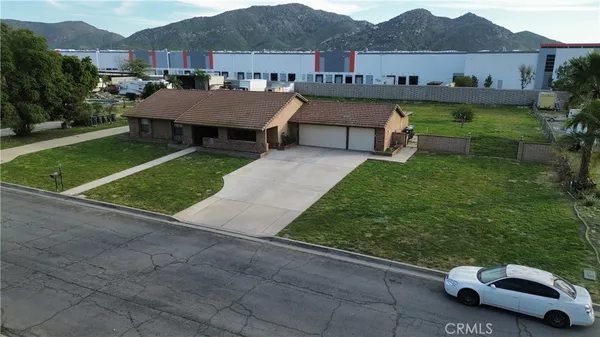 a view of a house with a backyard and a patio