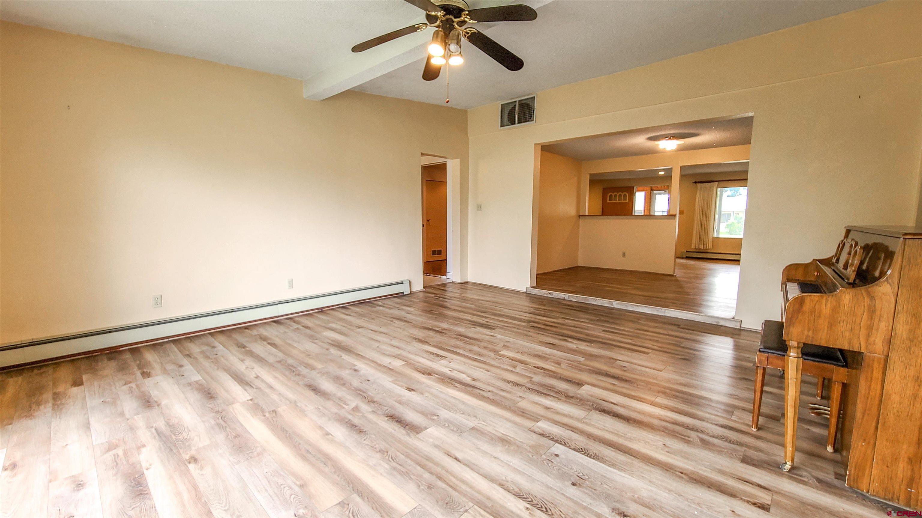 2916 East 7/8 Road Grand Junction, CO 81504 - Photo 11 of 35 wooden floor in an empty room with a window