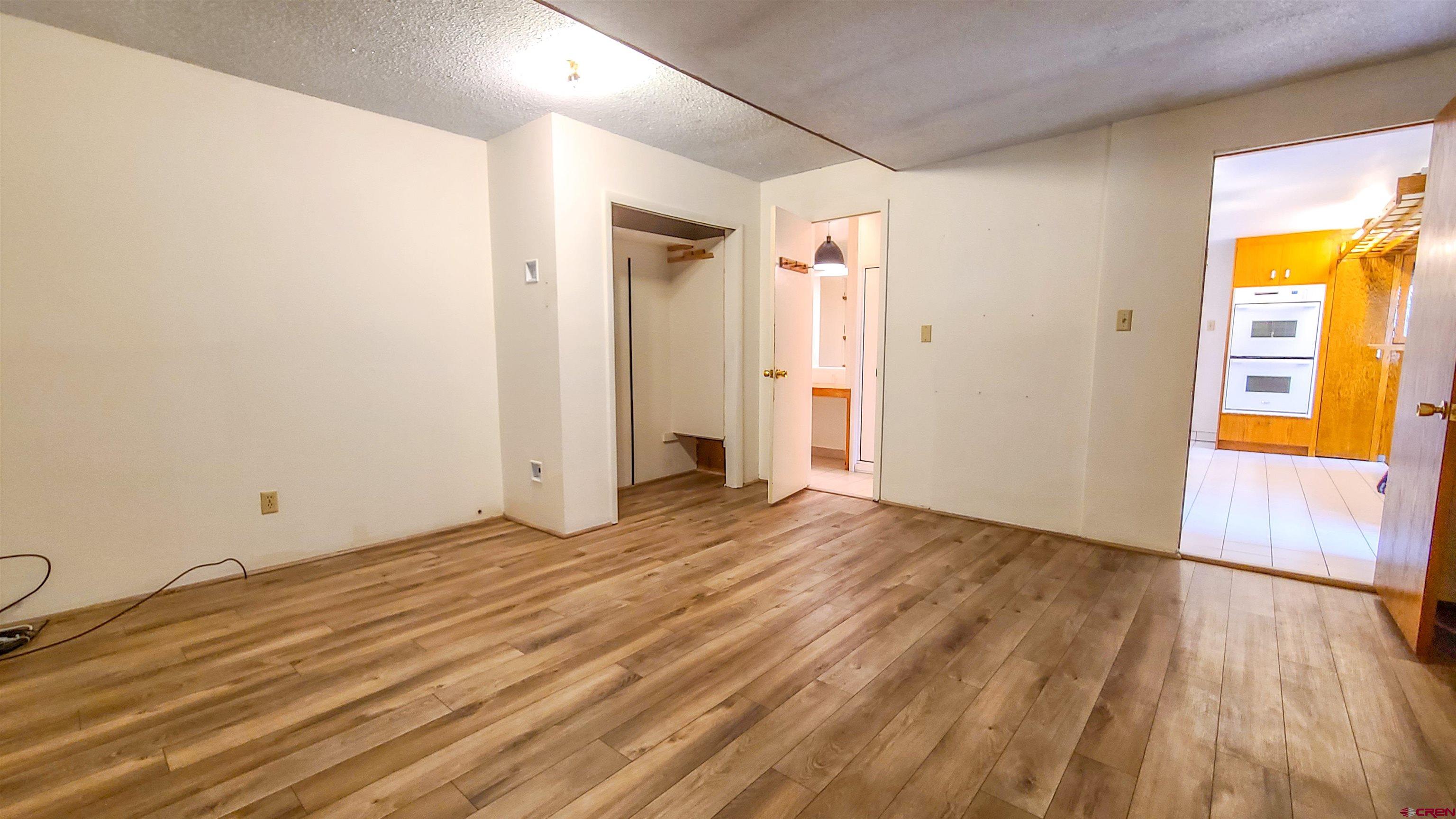 2916 East 7/8 Road Grand Junction, CO 81504 - Photo 19 of 35 a view of an empty room with wooden floor and a window