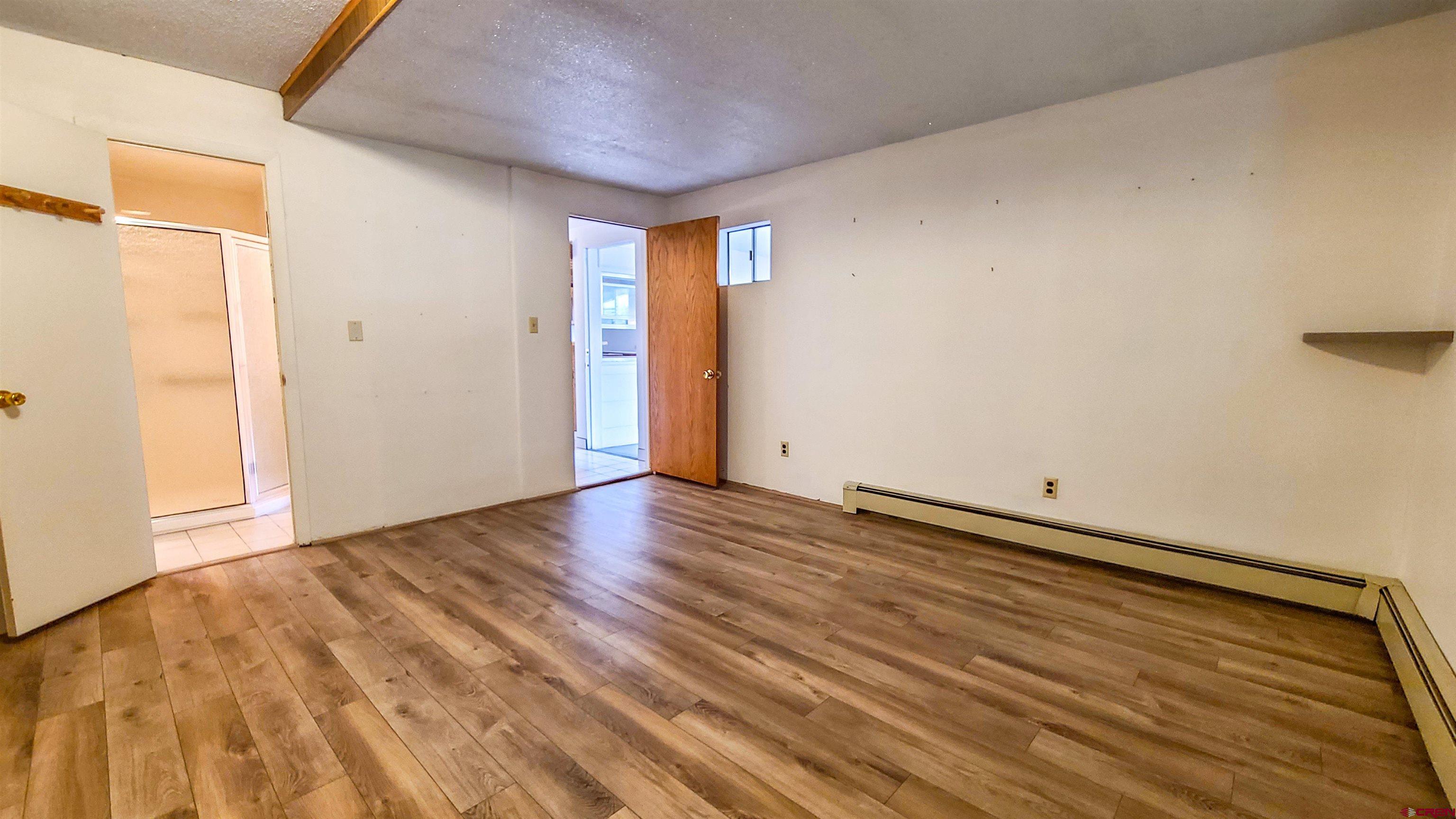 2916 East 7/8 Road Grand Junction, CO 81504 - Photo 20 of 35 a view of an empty room with wooden floor and a window