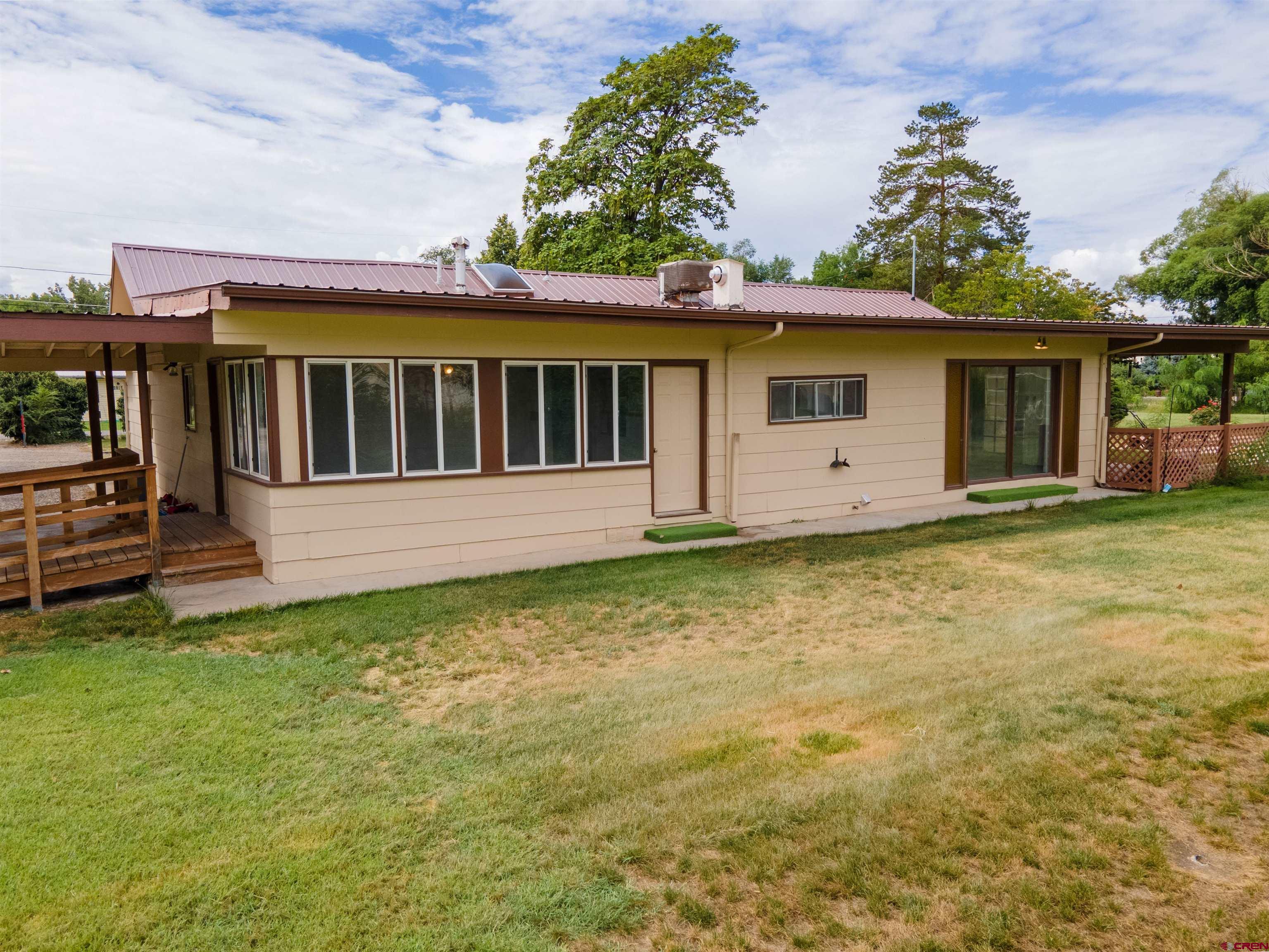 2916 East 7/8 Road Grand Junction, CO 81504 - Photo 2 of 35 a view of a house with a backyard