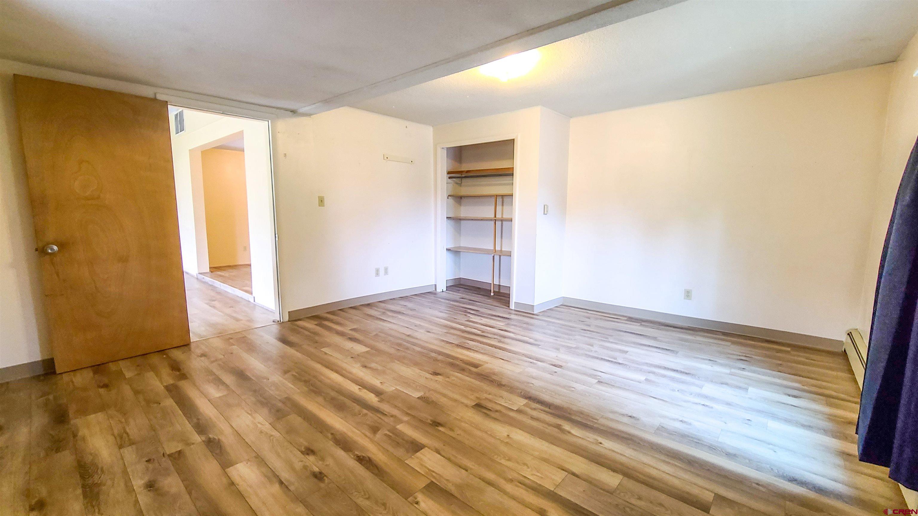 2916 East 7/8 Road Grand Junction, CO 81504 - Photo 22 of 35 a view of empty room with wooden floor and entryway