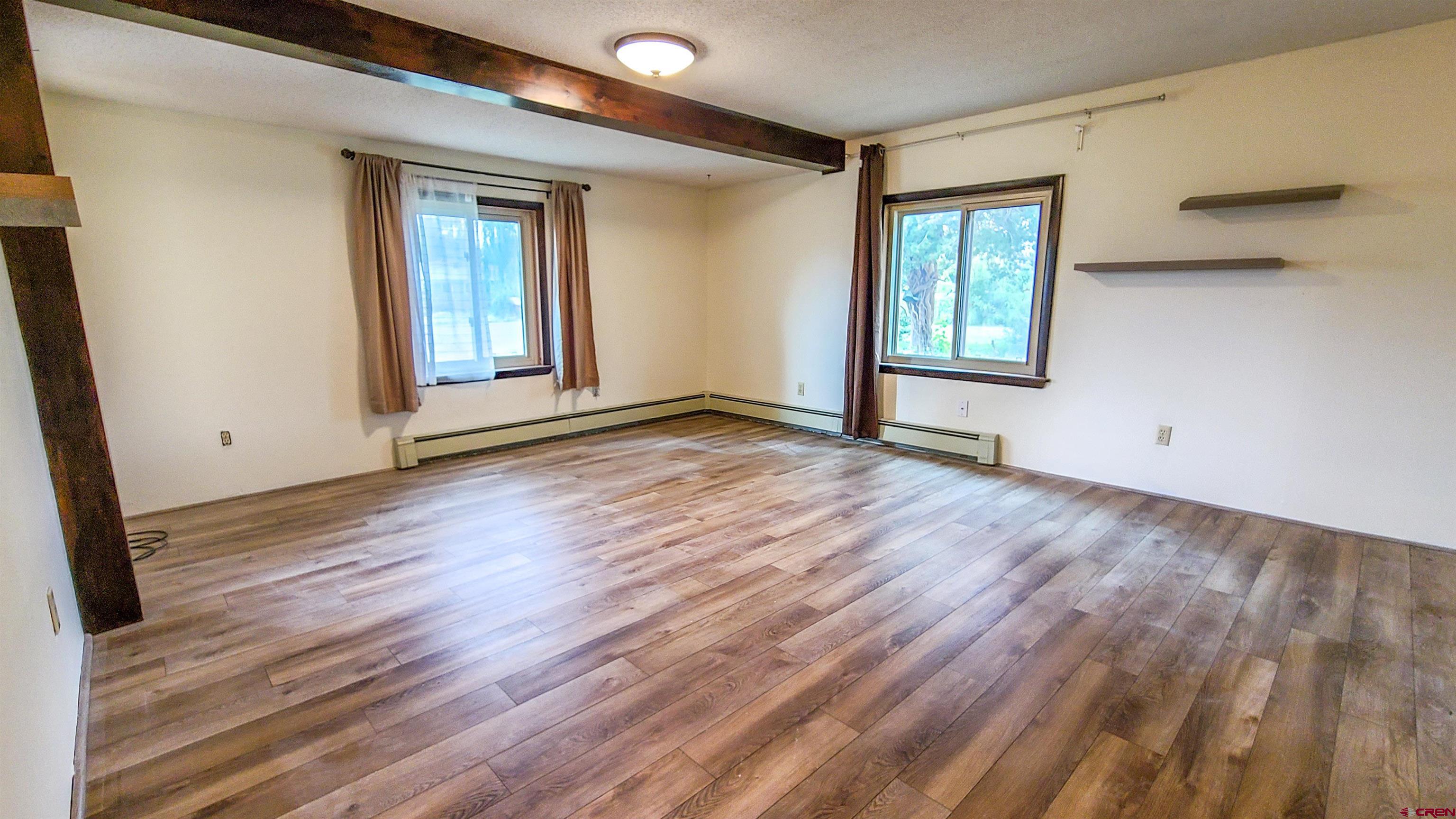 2916 East 7/8 Road Grand Junction, CO 81504 - Photo 24 of 35 a view of an empty room with wooden floor and a window