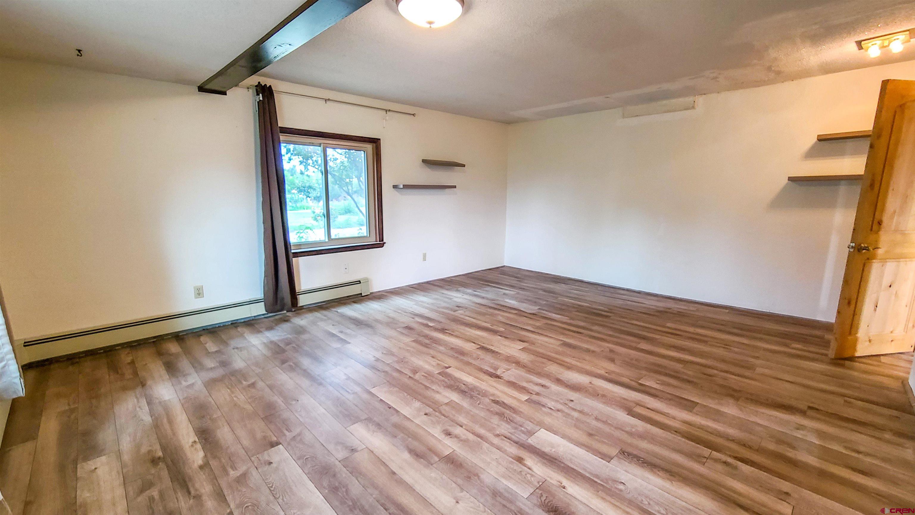 2916 East 7/8 Road Grand Junction, CO 81504 - Photo 25 of 35 a view of empty room with wooden floor and fan