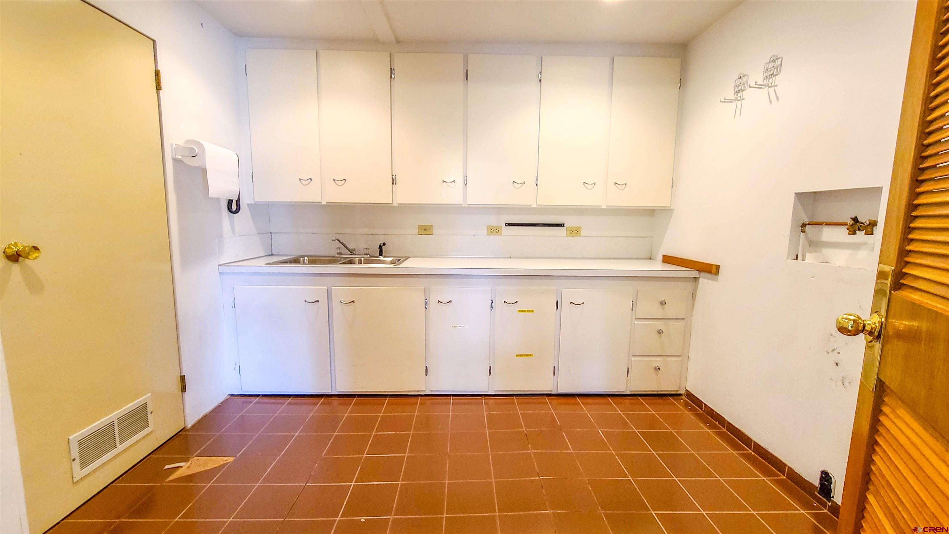 2916 East 7/8 Road Grand Junction, CO 81504 - Photo 26 of 35 a kitchen with a sink a stove and cabinets
