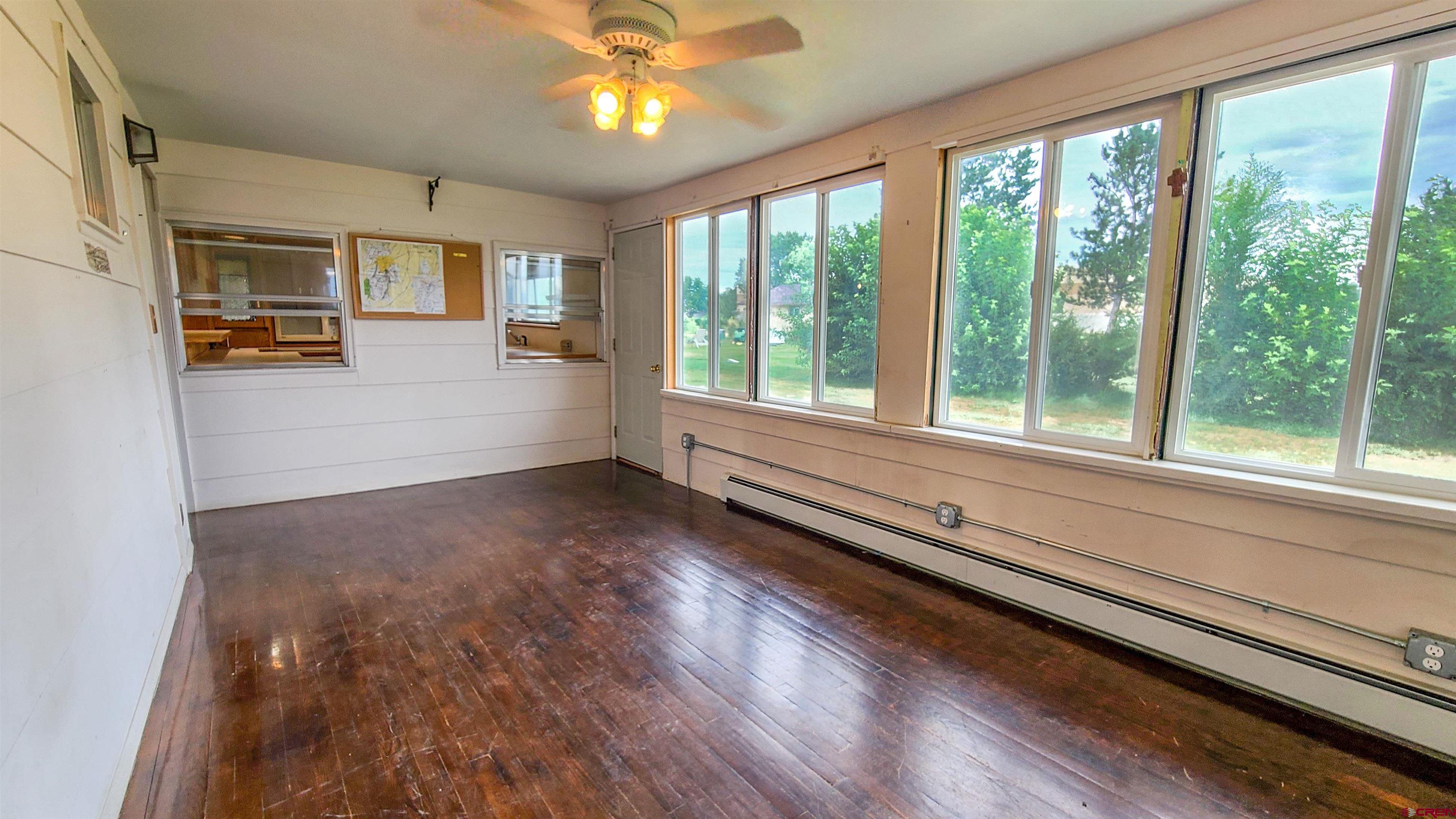2916 East 7/8 Road Grand Junction, CO 81504 - Photo 29 of 35 a view of a room with wooden floor and windows