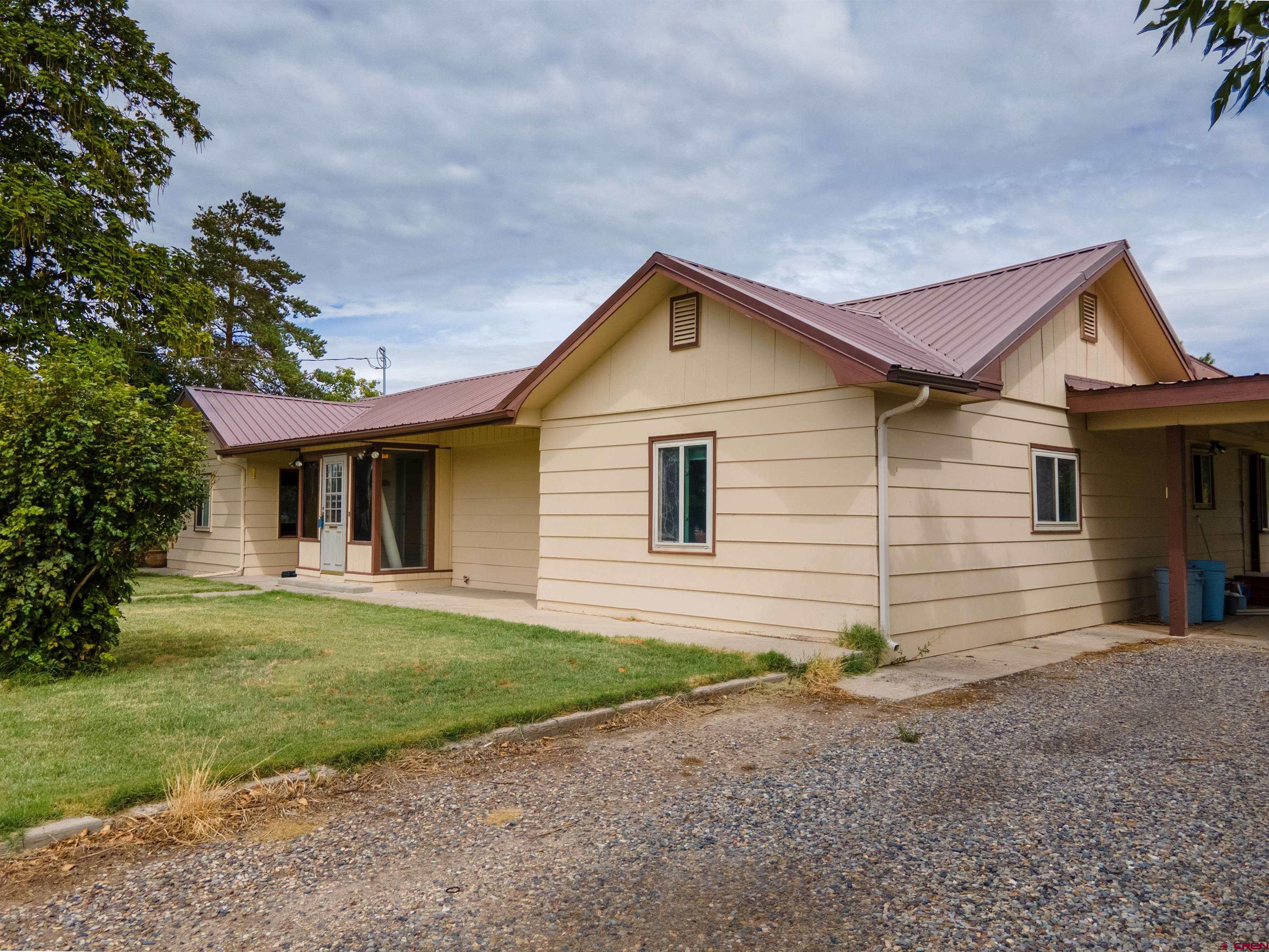 2916 East 7/8 Road Grand Junction, CO 81504 - Photo 35 of 35 a front view of a house with a yard and garage