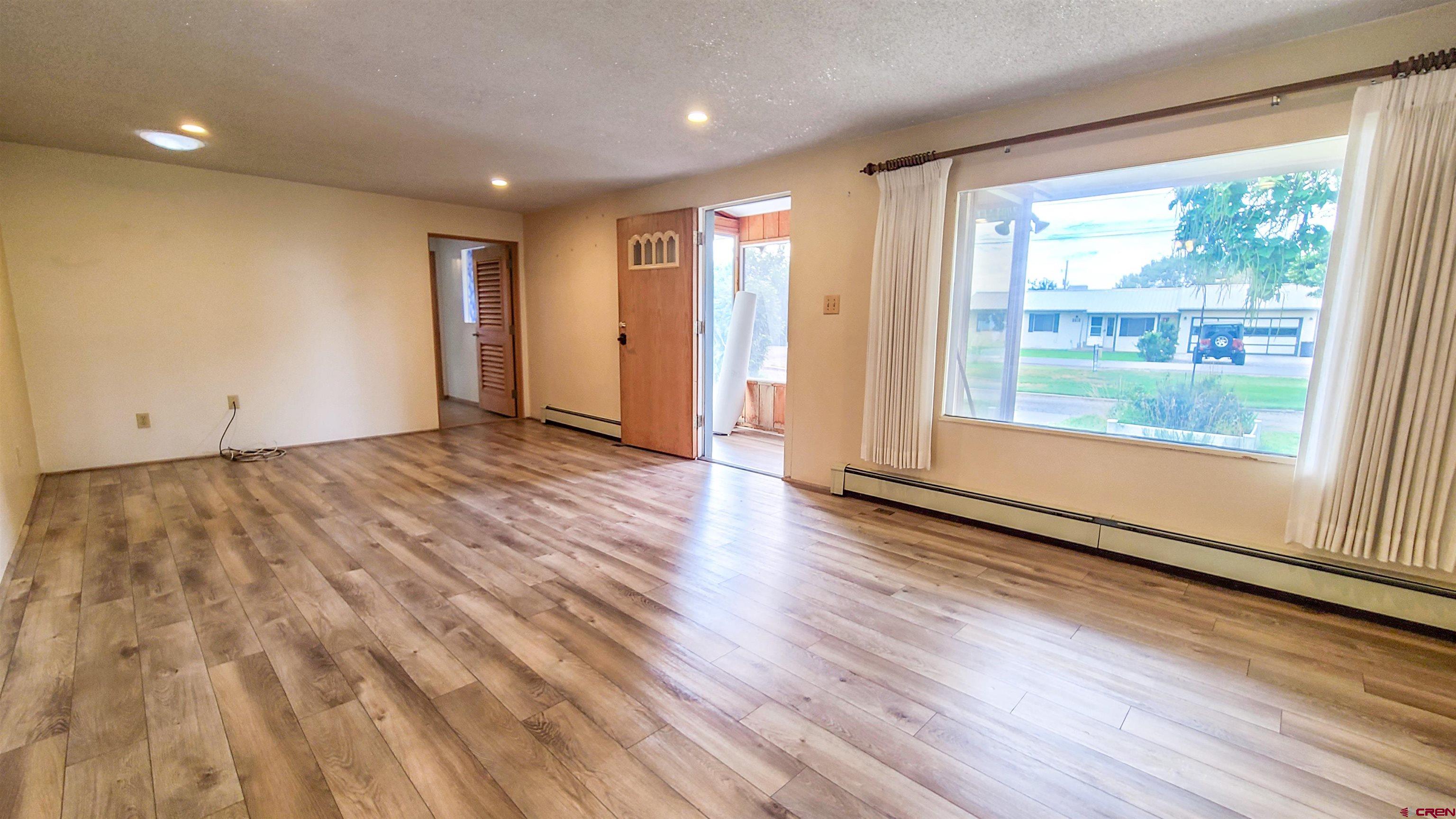 2916 East 7/8 Road Grand Junction, CO 81504 - Photo 5 of 35 a view of wooden floor and windows in a room