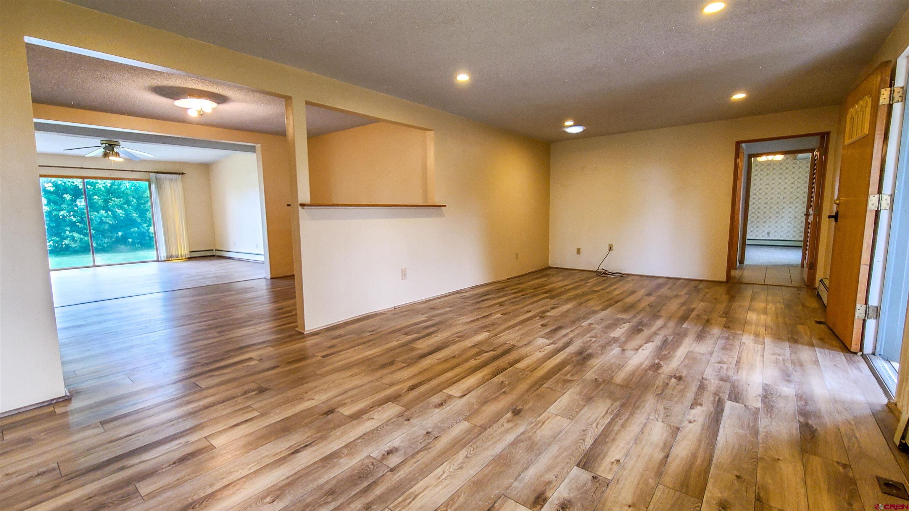 2916 East 7/8 Road Grand Junction, CO 81504 - Photo 8 of 35 a view of empty room with wooden floor and fan