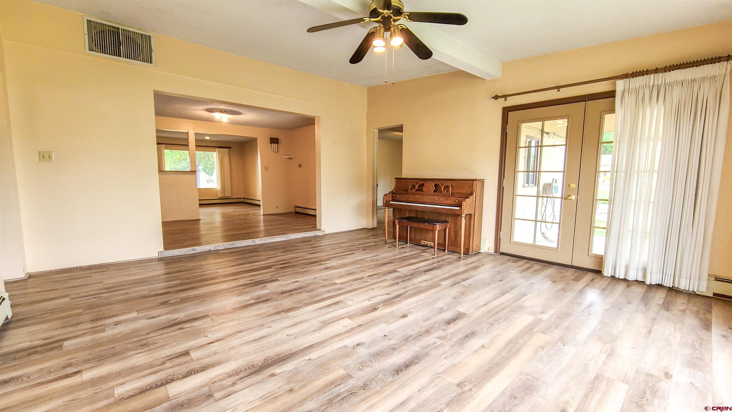 2916 East 7/8 Road Grand Junction, CO 81504 - Photo 10 of 35 a view of empty room with wooden floor and fan