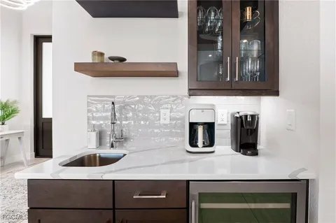 a kitchen with a sink and a refrigerator